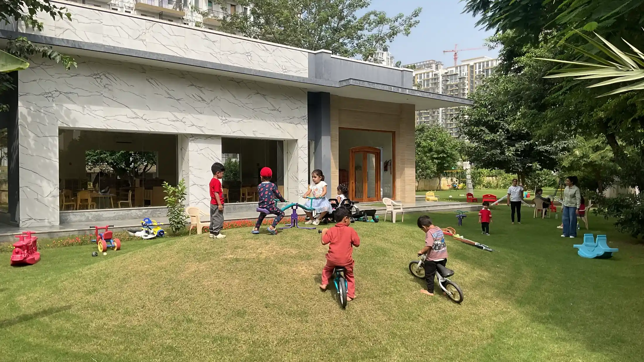 Sunlit outdoor learning landscape and contemporary architectural facade of Sector 65 campus