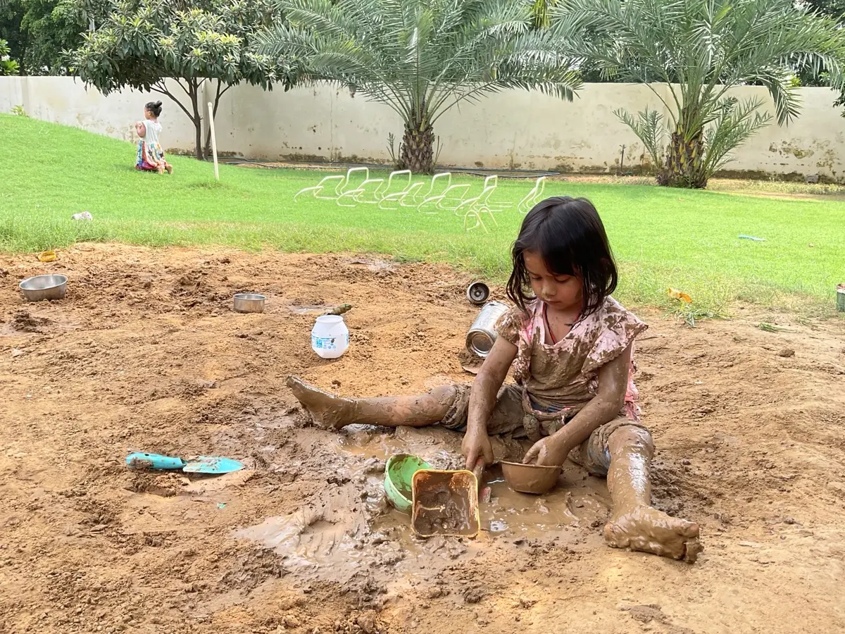 Toddlers playing in the garden slopes at Productive Minds
